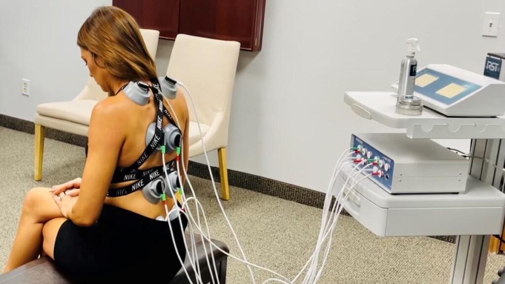 A woman sitting in front of a bunch of wires.